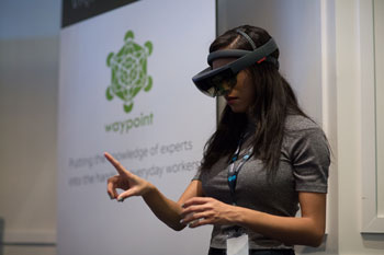 Woman wearing VR goggles and pointing